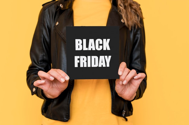 Woman holding black friday label