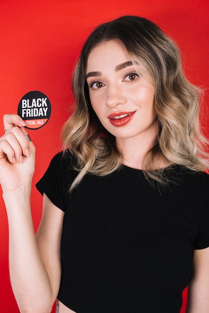 Woman holding black friday sticker