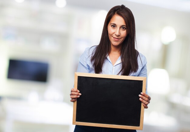 Woman holding a blackboard