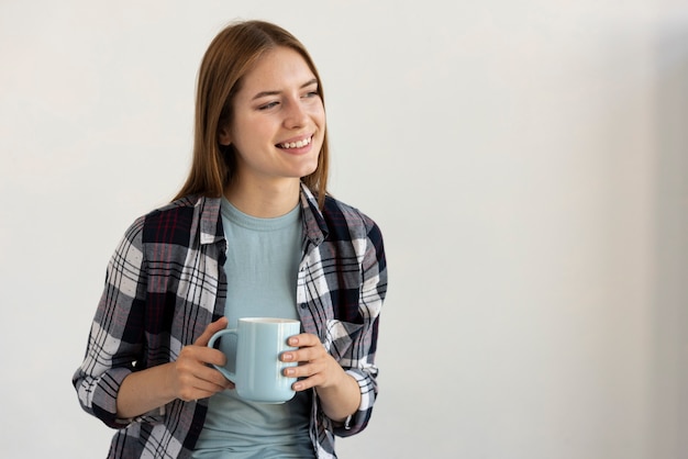 Woman holding a blue cup of coffee