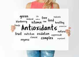 Free photo woman holding a board with antioxidants concept