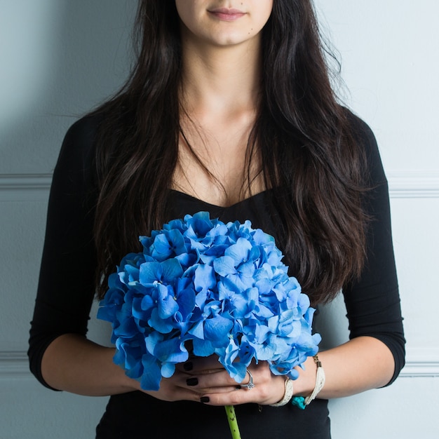 Woman holding a bouquet of sky blue sirens