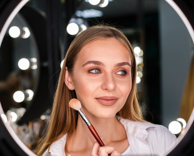 Woman holding brush looking away