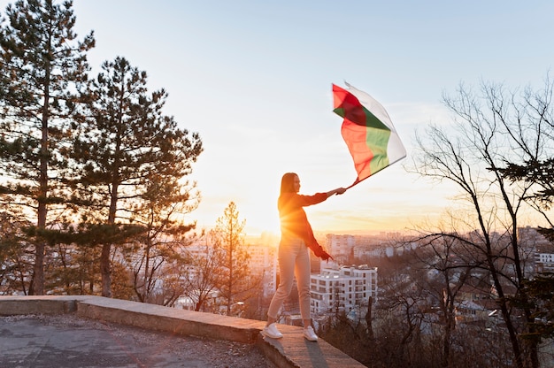 Free photo woman holding bulgarian flag outdoors