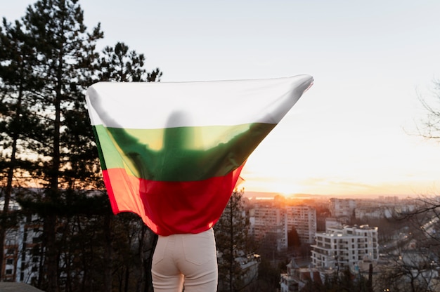 Woman holding bulgarian flag outdoors