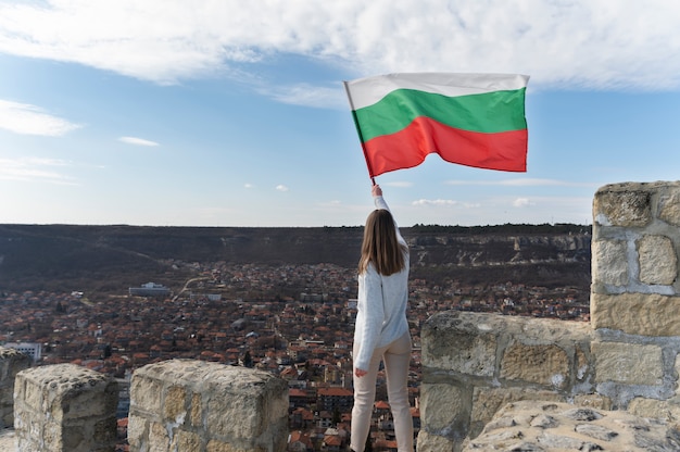 Woman holding bulgarian flag outdoors