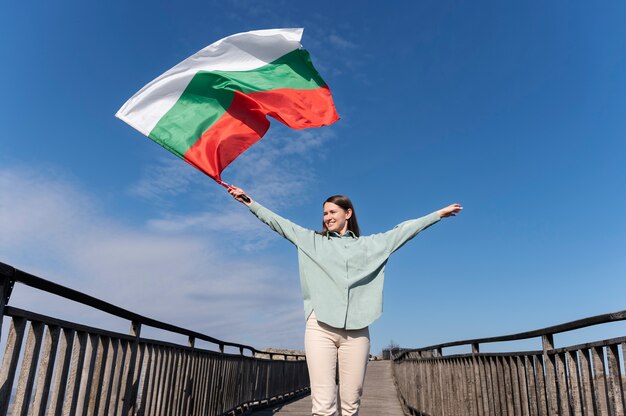 Woman holding bulgarian flag outside