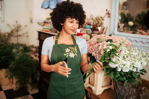Woman holding bunch of flowers in shop