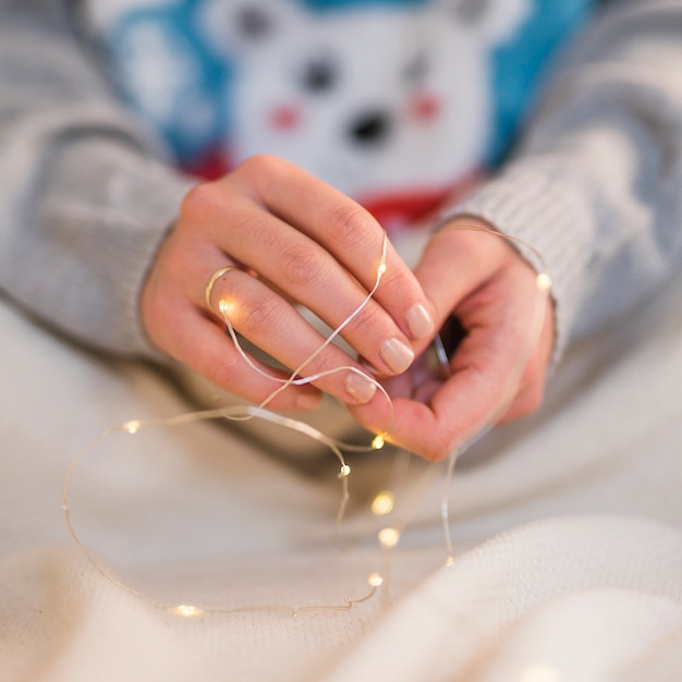 Free photo woman holding burning garland in hands