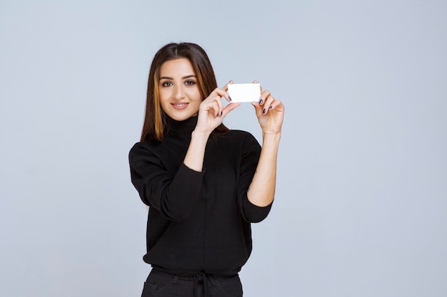 woman holding a business card and introducing herself. 