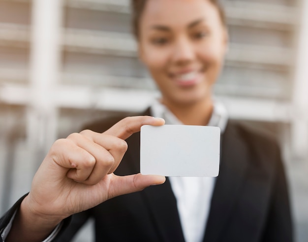 Woman holding business card mock-up