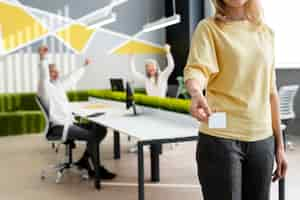 Free photo woman holding business card at office