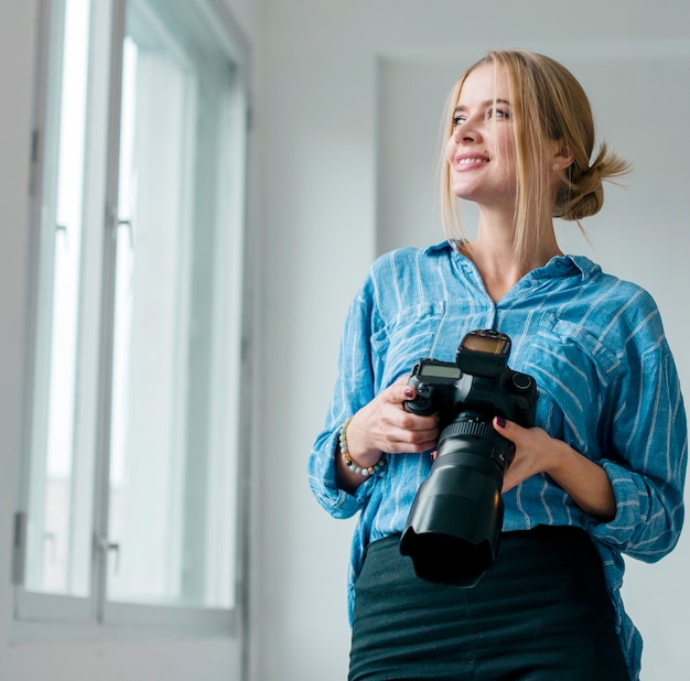 Woman holding a camera and looking through windows