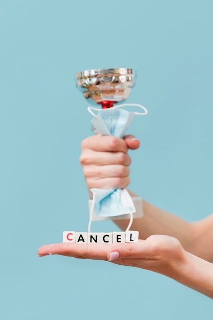 Free photo woman holding a canceled message made from little cubes