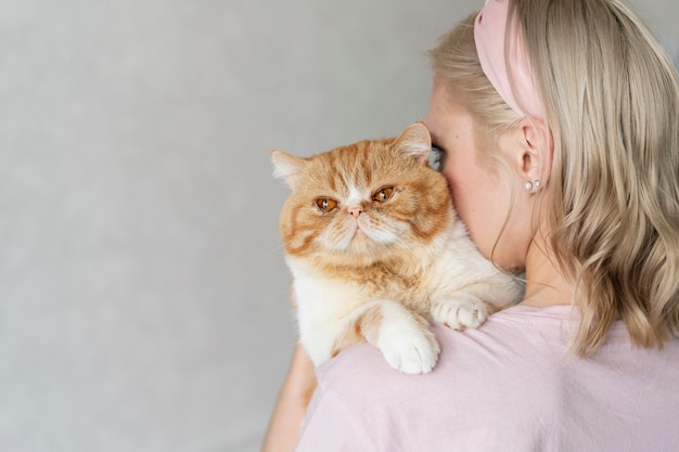 Woman holding cat close up