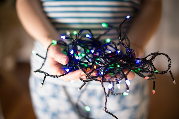 Woman holding christmas lights