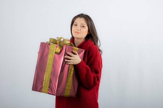 Woman holding Christmas or new year decorated gift box . 