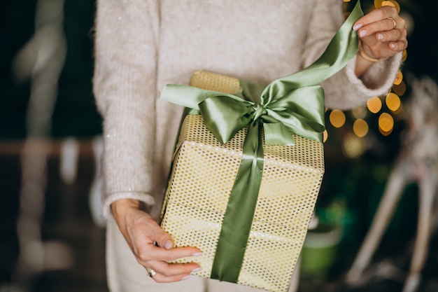 Woman holding a Christmas present, box close up