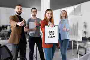 Free photo woman holding a clipboard with join our team message