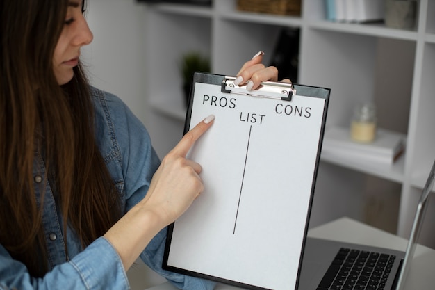 Woman holding clipboard with list