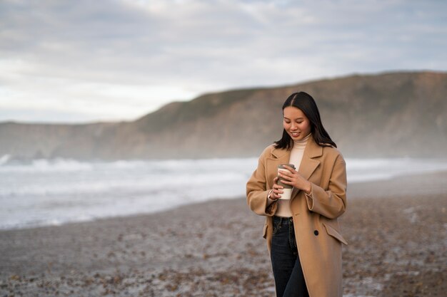 Free photo woman holding coffee cup medium shot