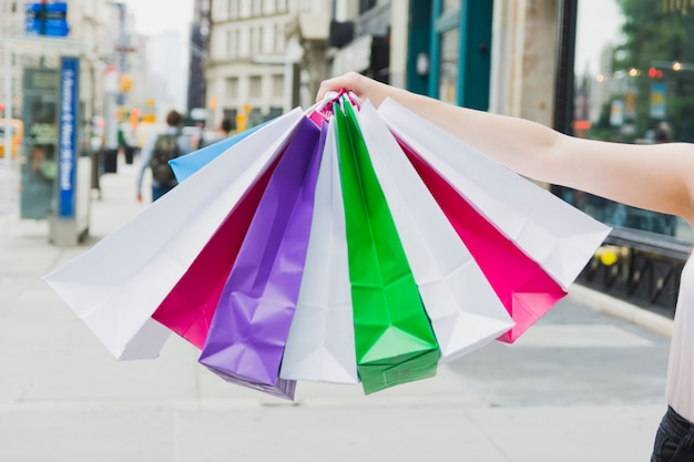 Woman holding colourful shopping bags