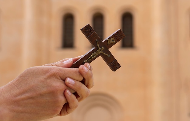 Woman holding a crucifix at church