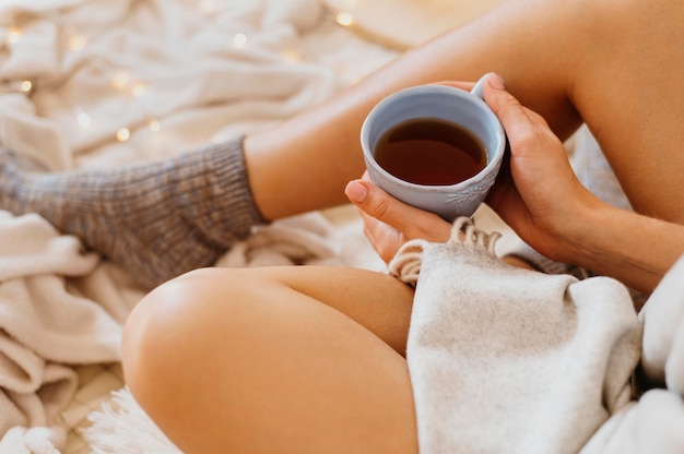 Woman holding a cup of tea while enjoying the winter holidays