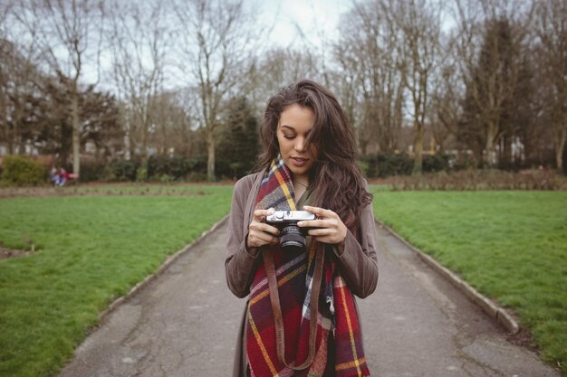 Free photo woman holding digital camera