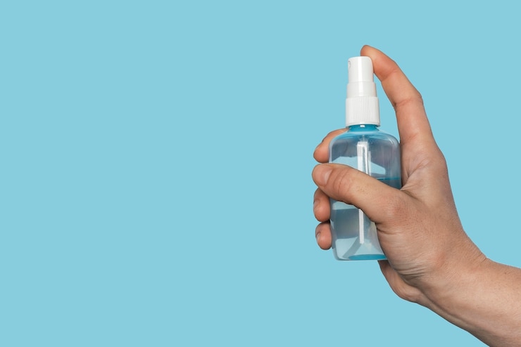 Free Photo woman holding a disinfectant bottle