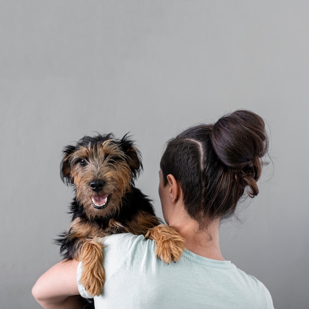 Woman holding dog with copy-space