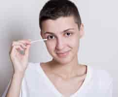 Free photo woman holding an ear cotton bud