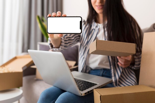 Woman holding an empty screen phone while cyber monday sales