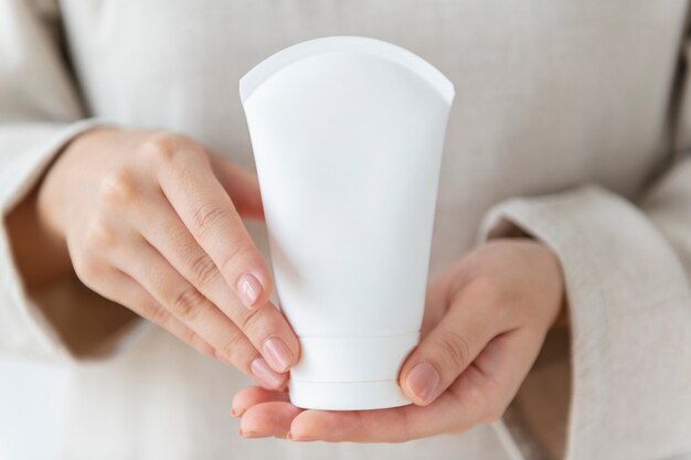 Woman holding  a facial cream tube