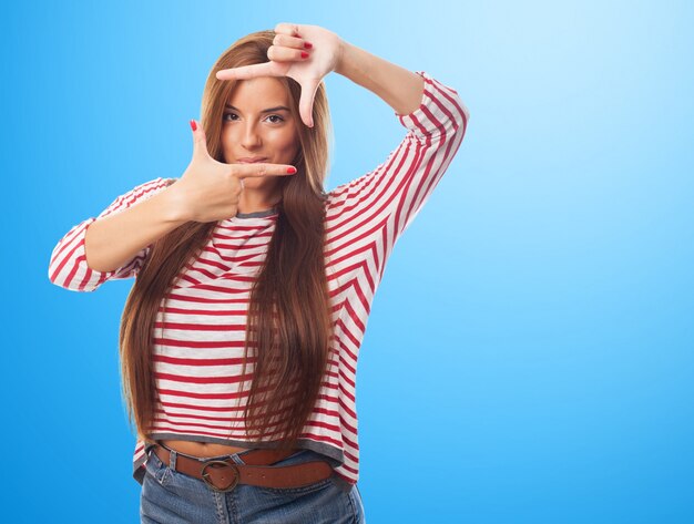 Woman holding fingers frame like frame. 