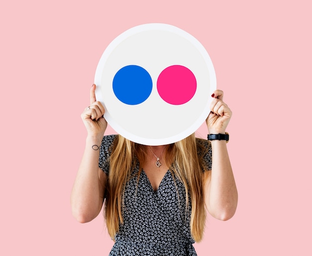 Woman holding a Flickr icon