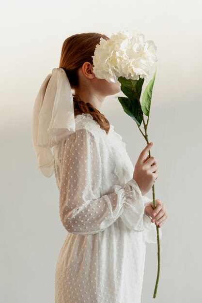 Woman holding flower side view