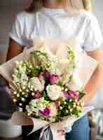 Free photo woman holding flowers bouquet close up