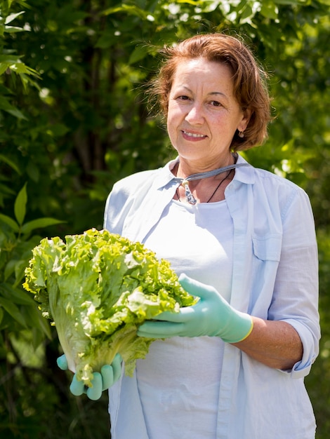 Free photo woman holding a fresh cabbage