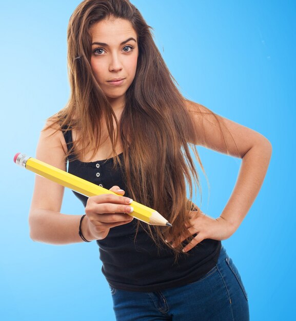 Woman holding a giant pencil