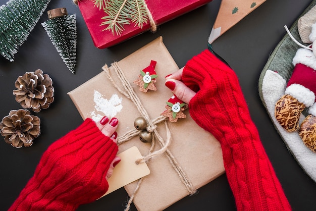 Woman holding gift box on table