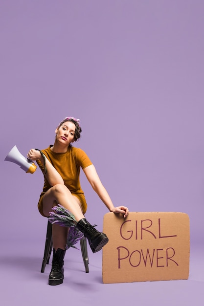 Woman holding "girl power" cardboard gender equality and copy space