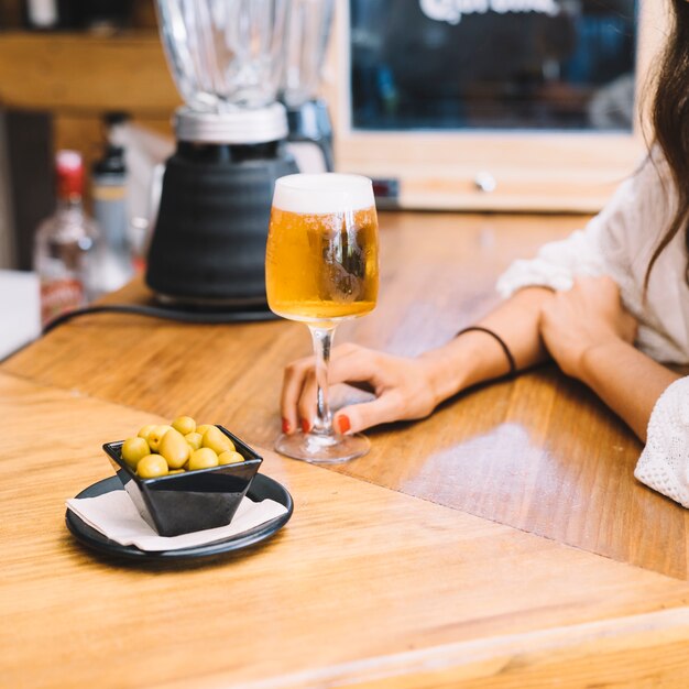 Woman holding glass of beer