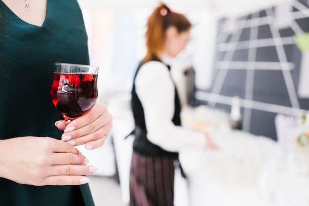 Woman holding glass with alcohol