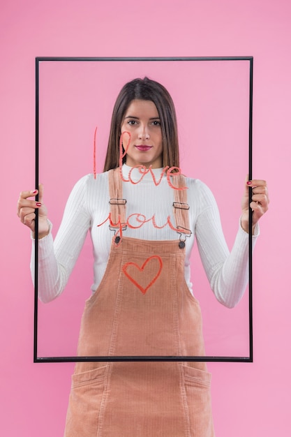 Free photo woman holding glass with i love you inscription