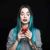 Free photo woman holding goblet with red drink