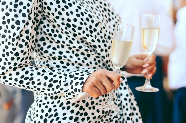 Free photo woman holding goblets with champagne