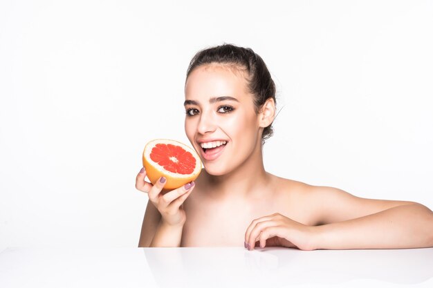 Woman holding grapefruit