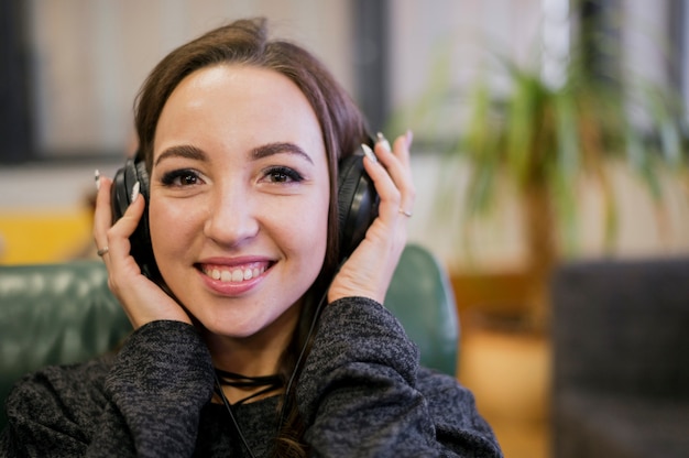 Woman holding headphones on head