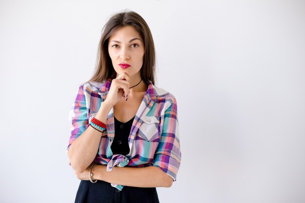 Woman holding her arm on chin having an idea